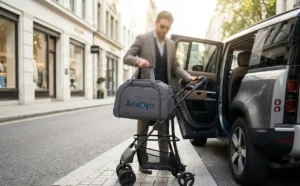 Man in a suit placing a gray Anvoya bag on a stroller, next to an open car door, in a stylish city street.